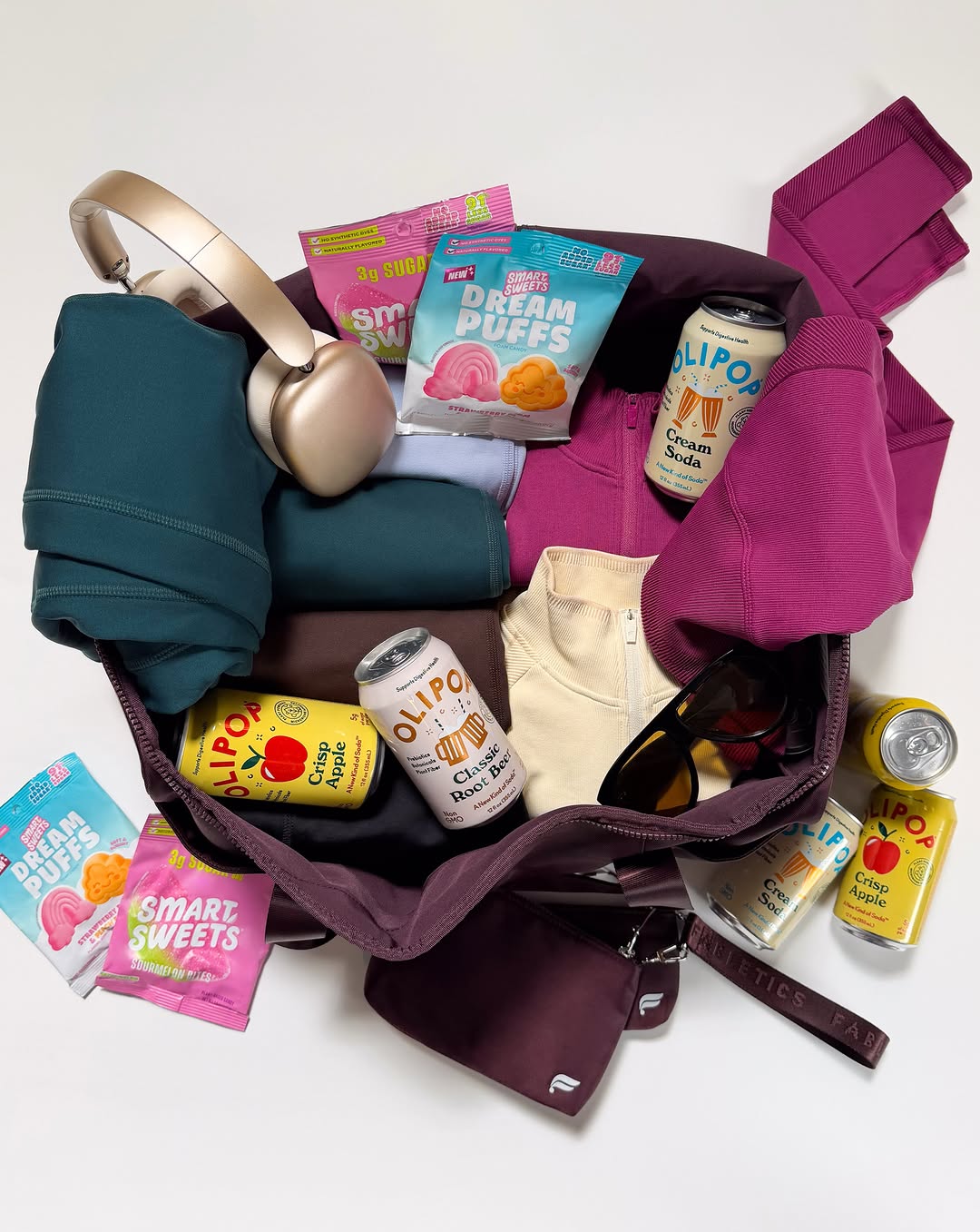 An open Fabletics duffel packed with folded activewear